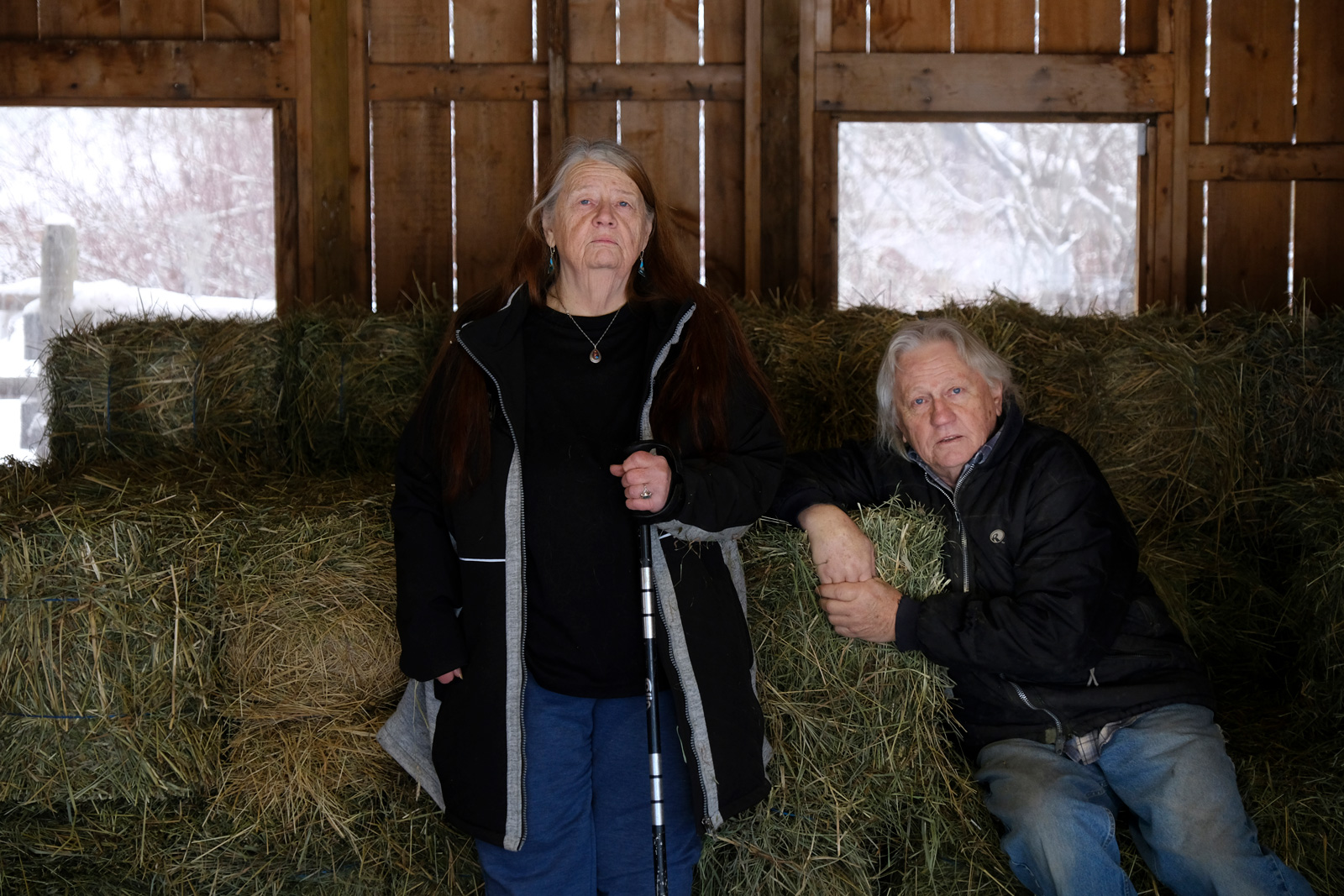 Two people standing in a barn