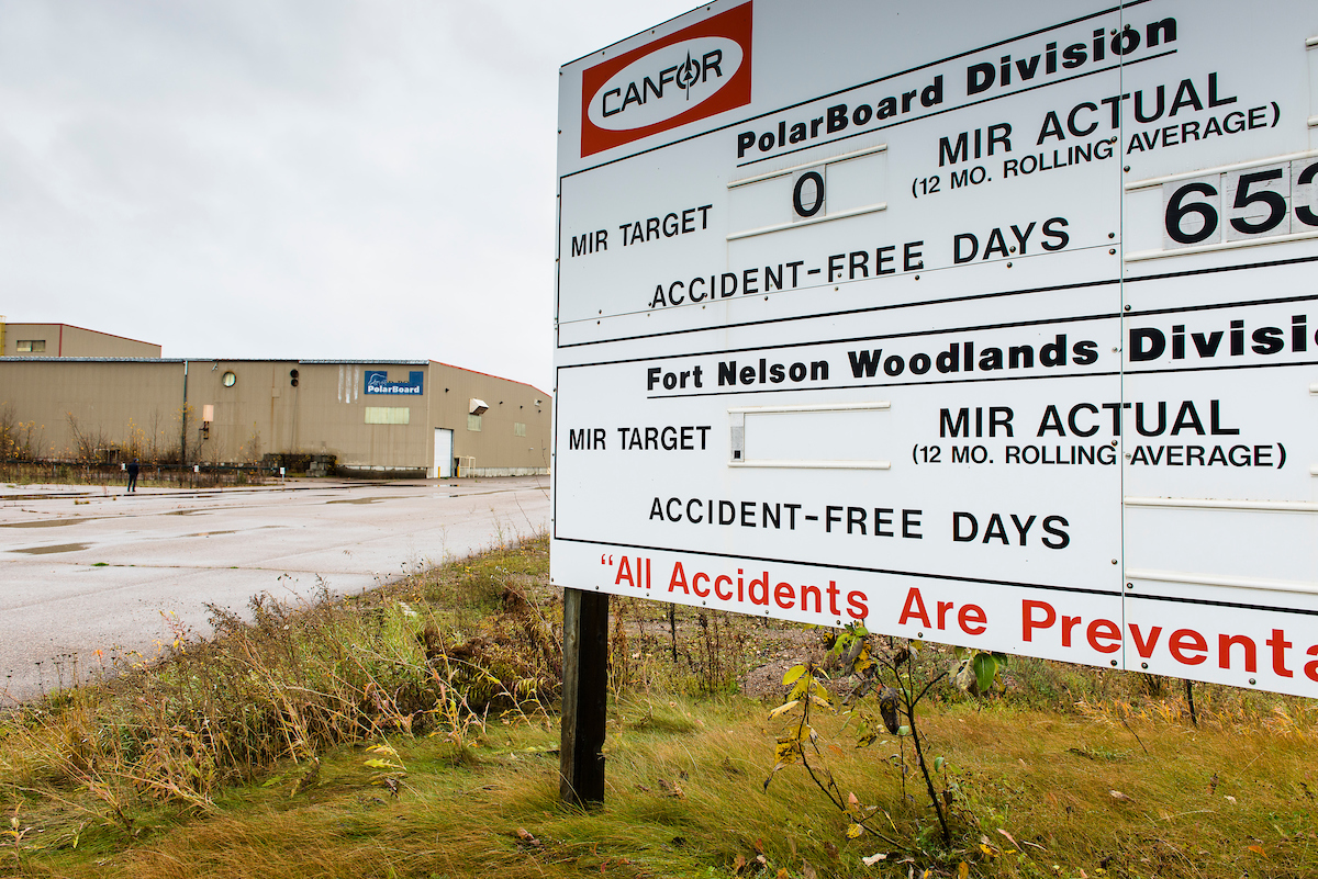 A Canfor sign stands outside a closed mill.