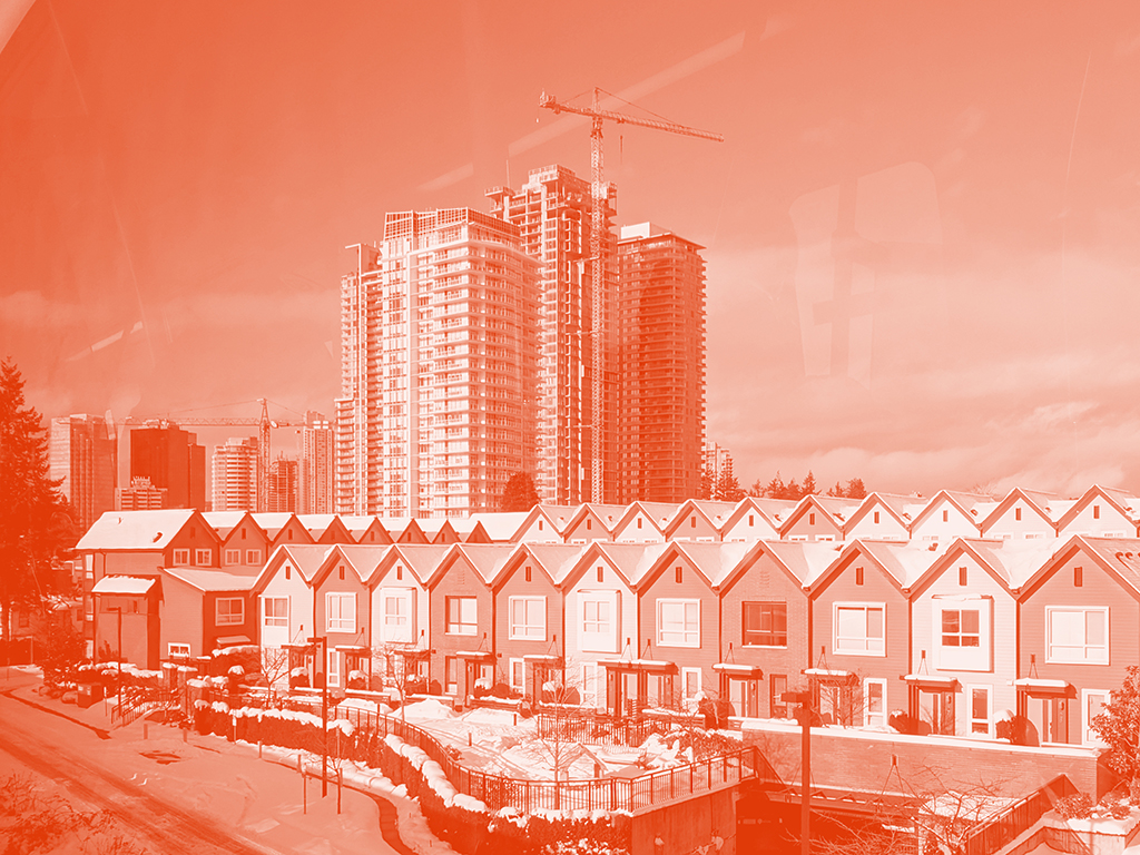 Rows of new modern townhouses in front, with new condo towers and a crane rising behind. It&rsquo;s winter and there&rsquo;s a cover of snow over this young neighbourhood.