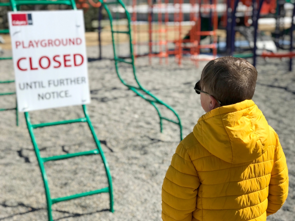 A child in a puffy yellow winter jacket 