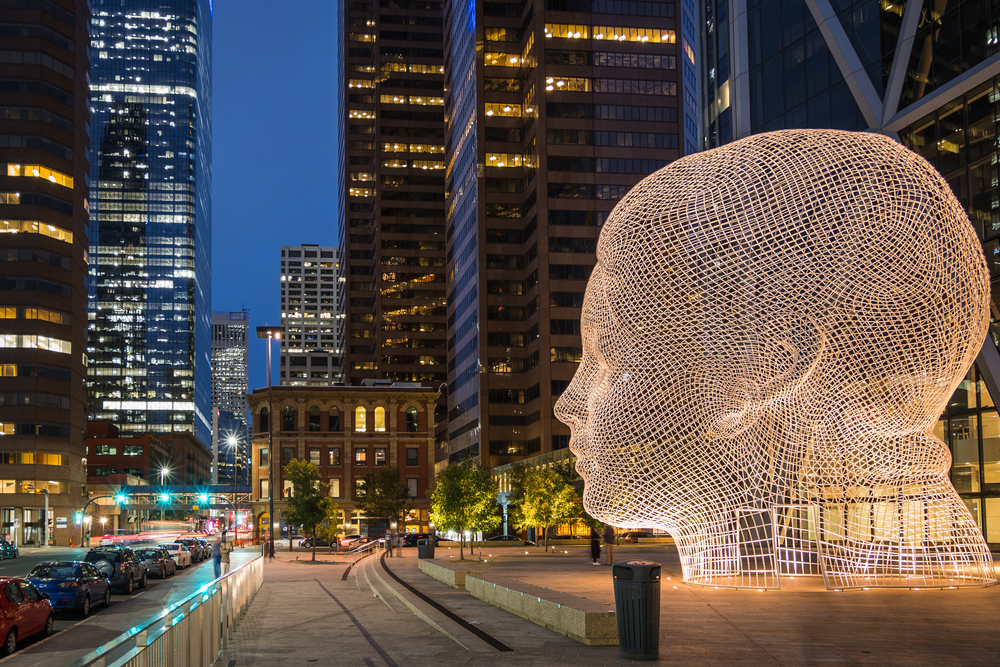 A light sculpture glows at night on a street in Calgary, Alberta.