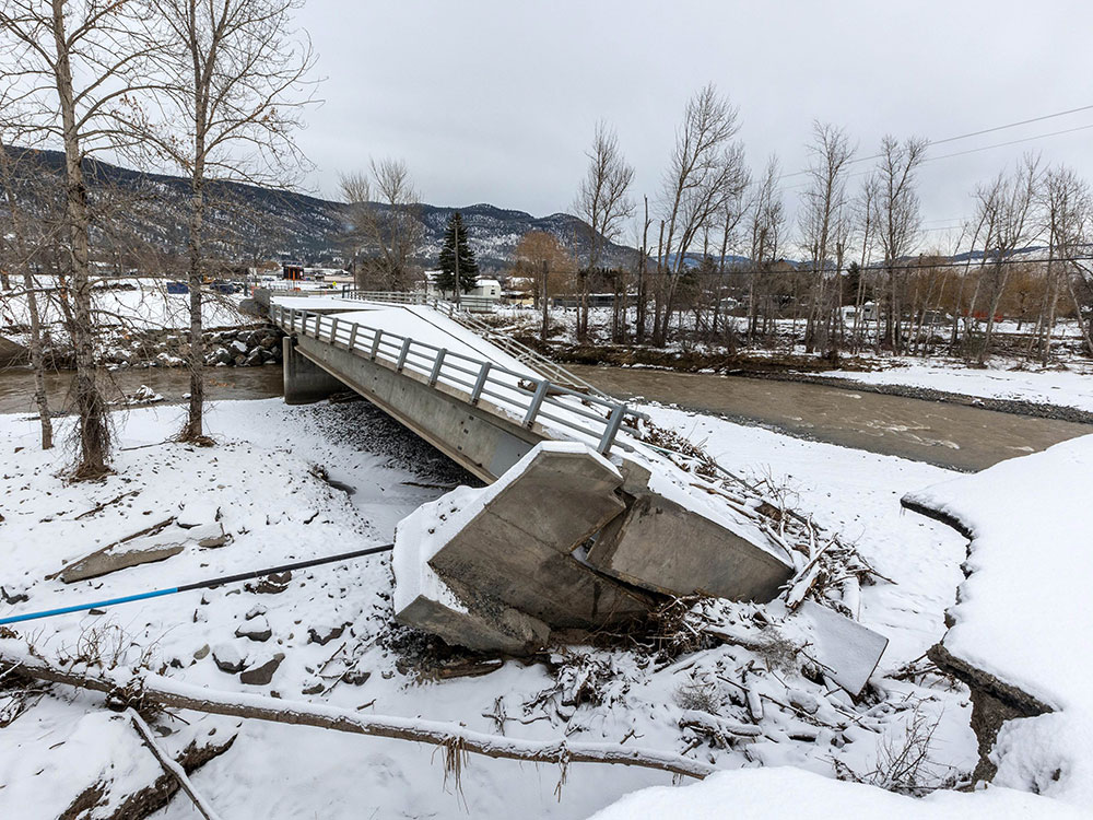 A concrete bridge is crumpled in the snow.