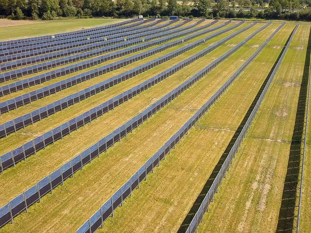 Rows of vertical panels divide productive farm fields.