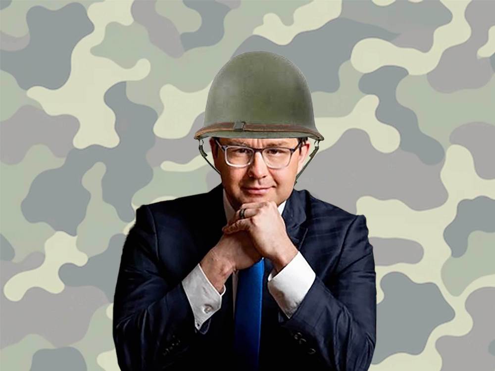 Pierre Poilievre sits in a dark suit with a white shirt and blue tie. He rests his chin in his hands and looks directly at the camera. He has short dark hair, light skin and glasses. A photo illustration tops his head with a green military helmet. A camouflage pattern is in the background.