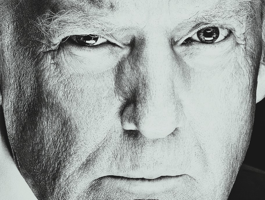A black-and-white, extreme closeup of Donald Trump with his eyes gazing deeply into the camera.