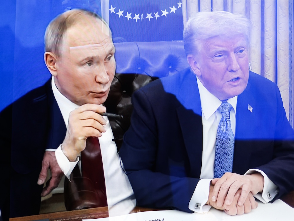 A blend of two photos places Putin and Trump side by side at desks.