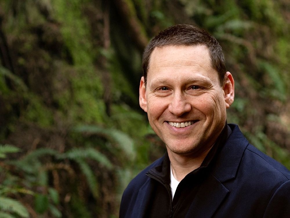 A man in his 50s with light skin and short brown hair smiles into the camera.