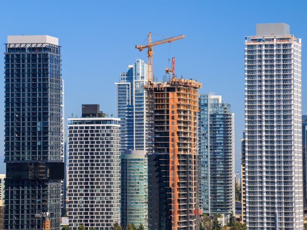 Many tall condo buildings, with a new one being built in the centre.