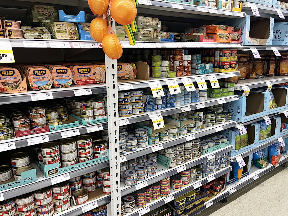 The canned fish aisle at a discount grocery store.