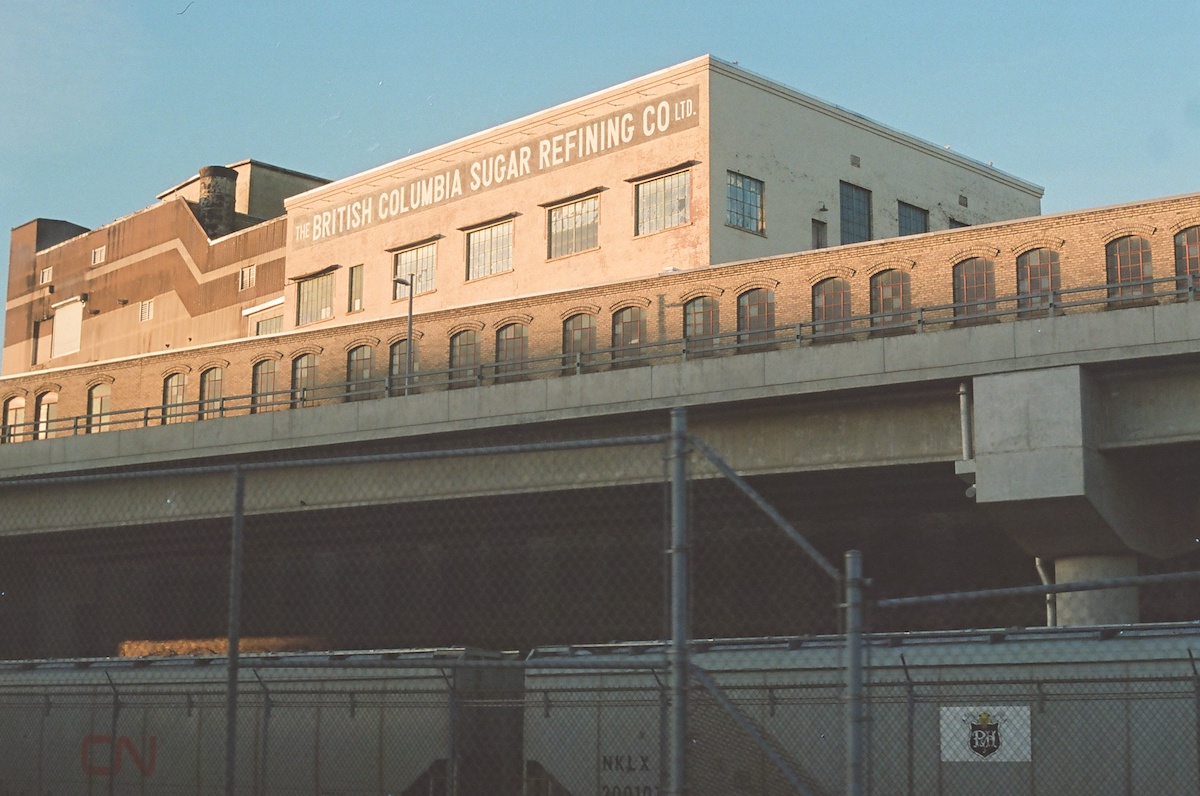 A photo taken in 2023 shows the exterior of the refinery at golden hour.