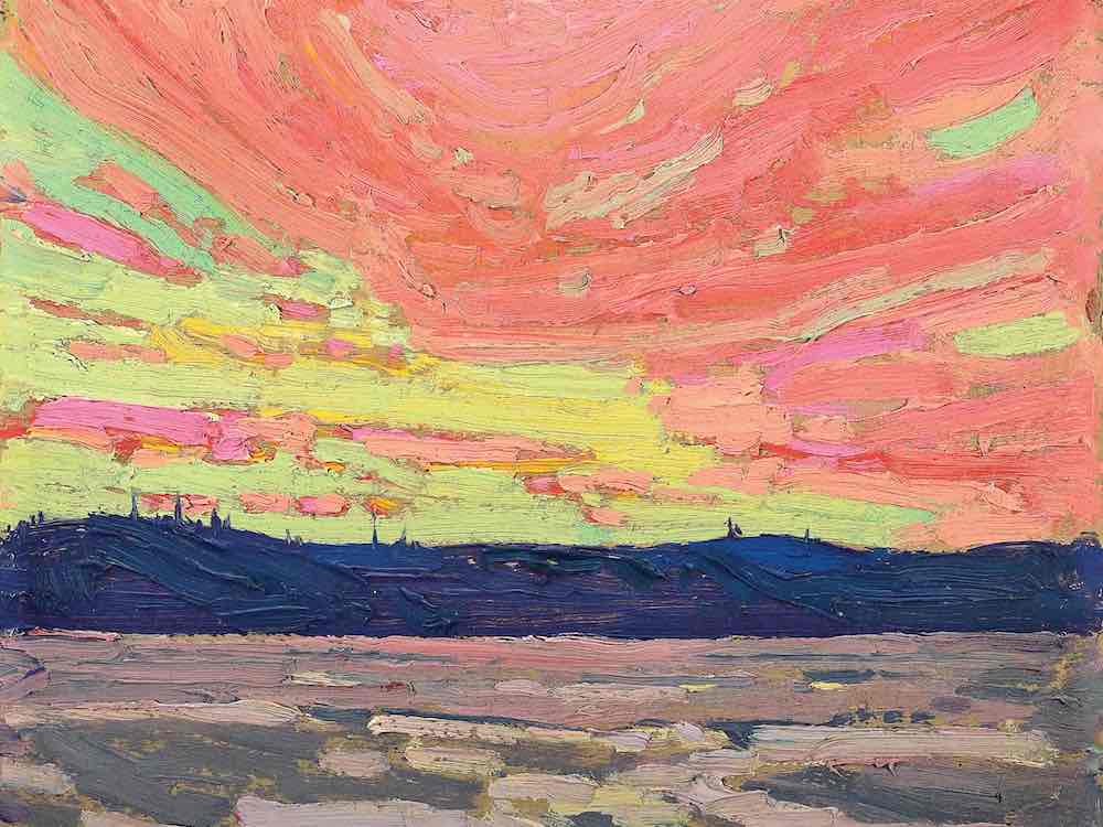 An oil painting of a big sky sunset uses pink, yellow and blue tones. On the horizon are blue hills. In the foreground is grey and blue water.