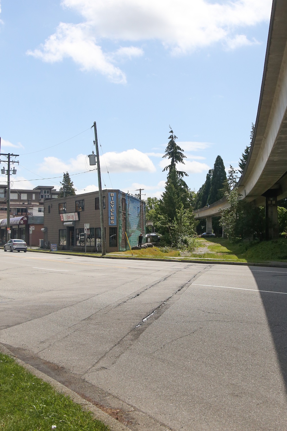 The ghosts of old rail tracks, partially paved over, are visible crossing a paved street.