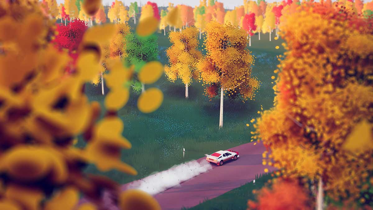 A small white race car drives along a purple digitally rendered roadway, flanked by green grass and trees with orange, yellow and red leaves.