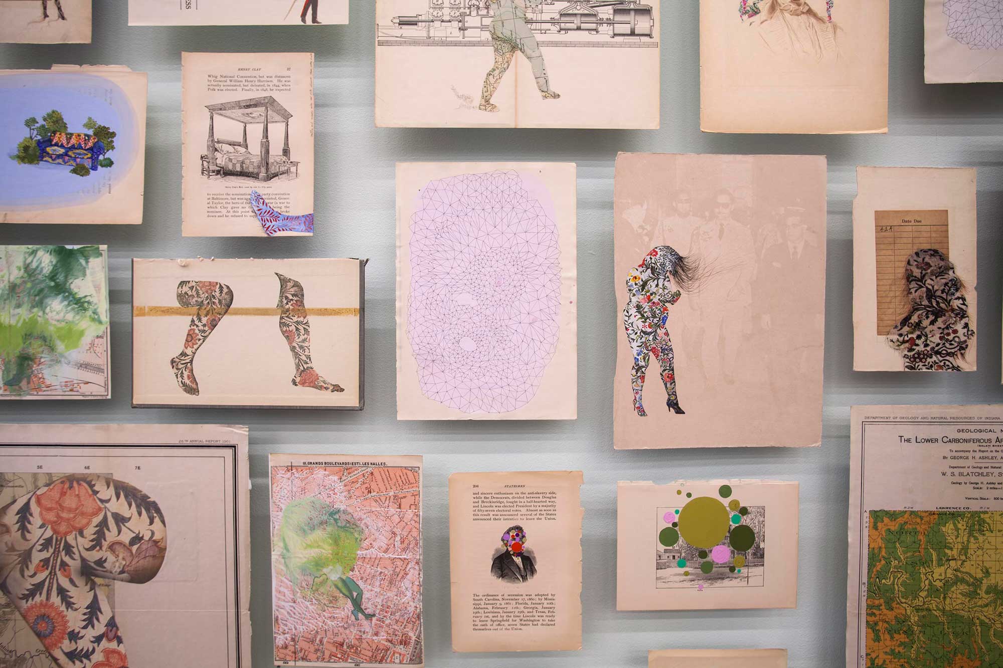A closeup photograph depicts details from a larger collection of small pieces of artwork mounted closely together against a grey gallery wall. The pieces depict women and women’s bodies in silhouette using bold floral patterns and collage work. There are also artistic treatments of deaccessioned book pages and other ephemera.