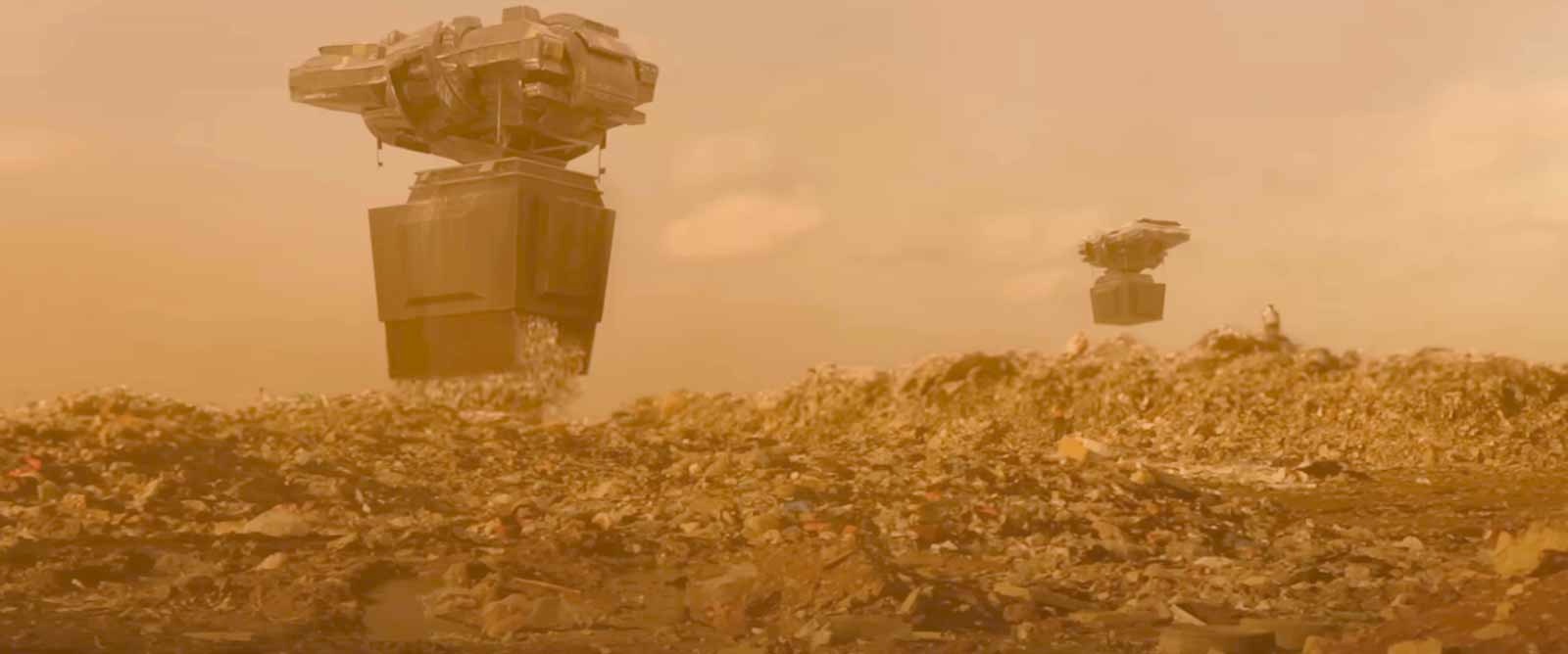 Large airborne machines carry cargo-style containers above a vast landscape of trash against an orange, hazy sky.