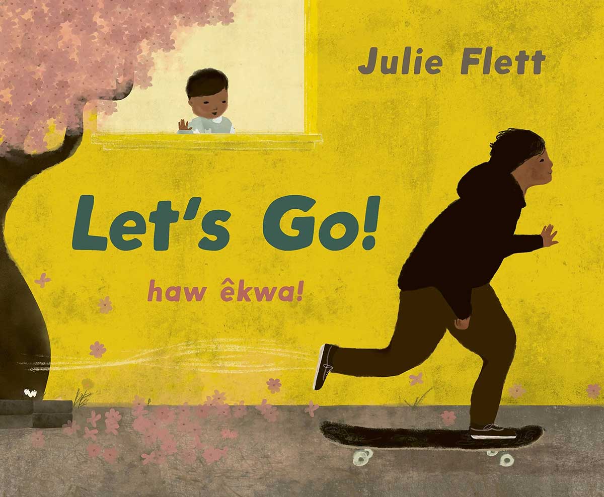 The book cover image for Let’s Go, a children’s book by Julie Flett, features a skateboarder skating past a building with a yellow wall from which a child is looking on from a window. A pink cherry blossom tree stands to the left of the frame.
