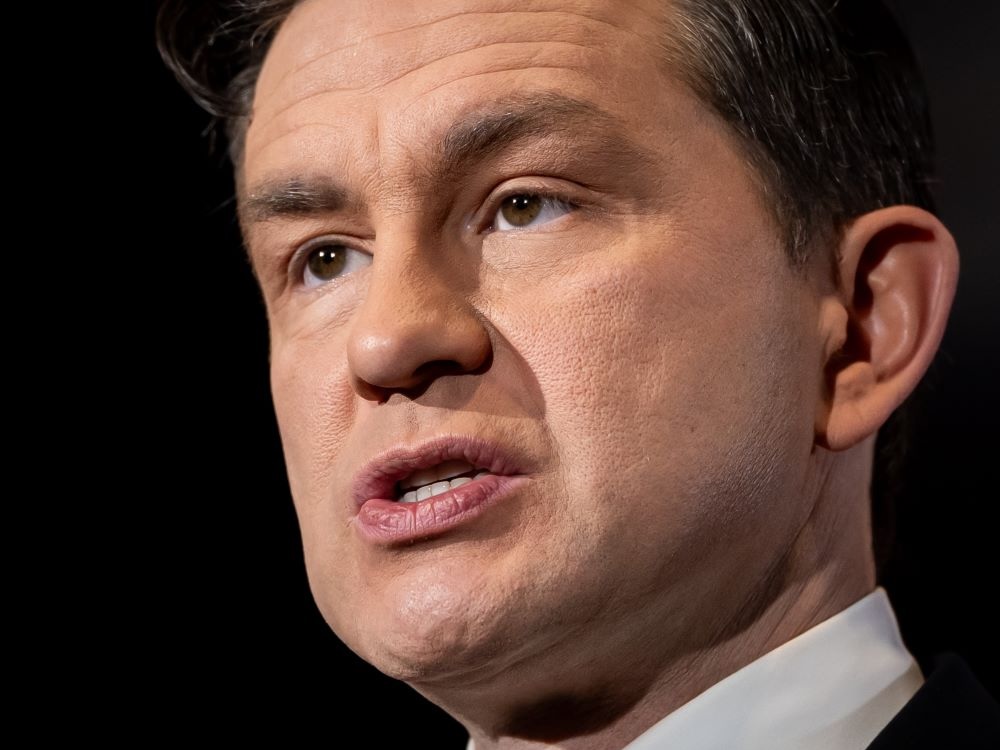 Close-up of the face of Pierre Poilievre, a light-skinned man with short brown hair and brown eyes.