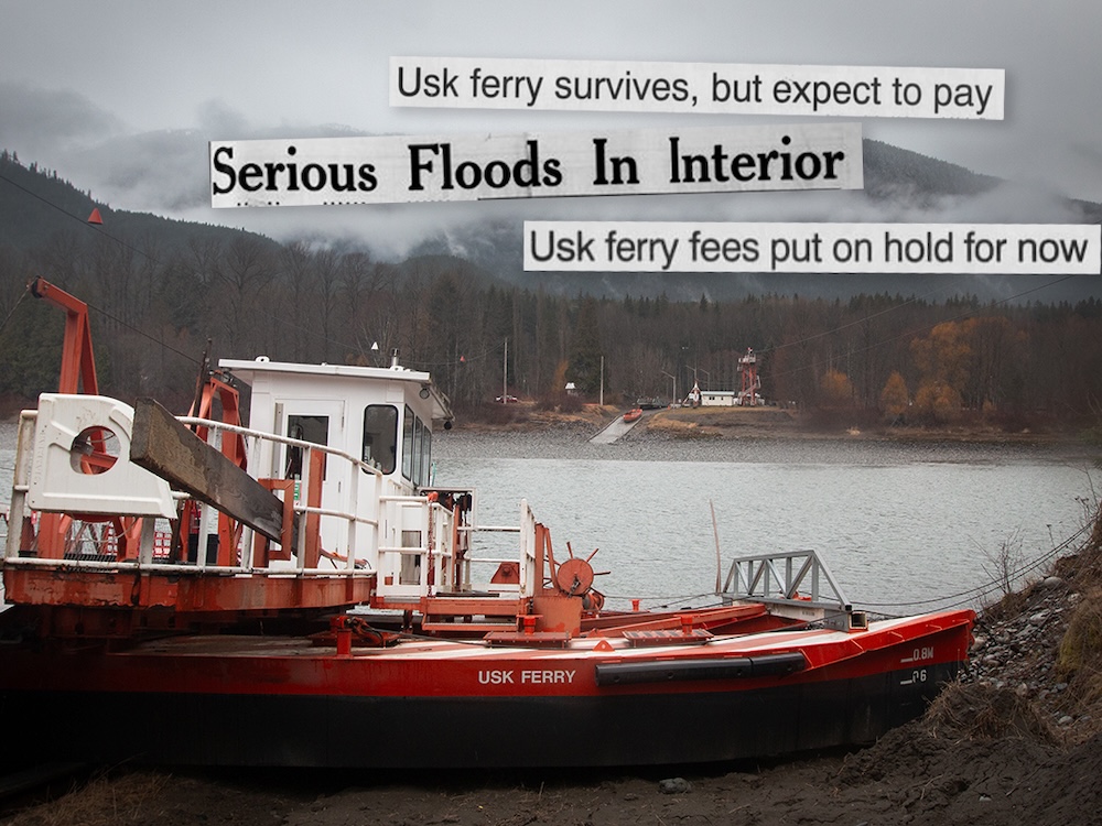 An orange and white vessel with the words ‘Usk ferry’ printed on the side sits on the shore next to a wide river. In the background are forested mountains with fog hanging over them.