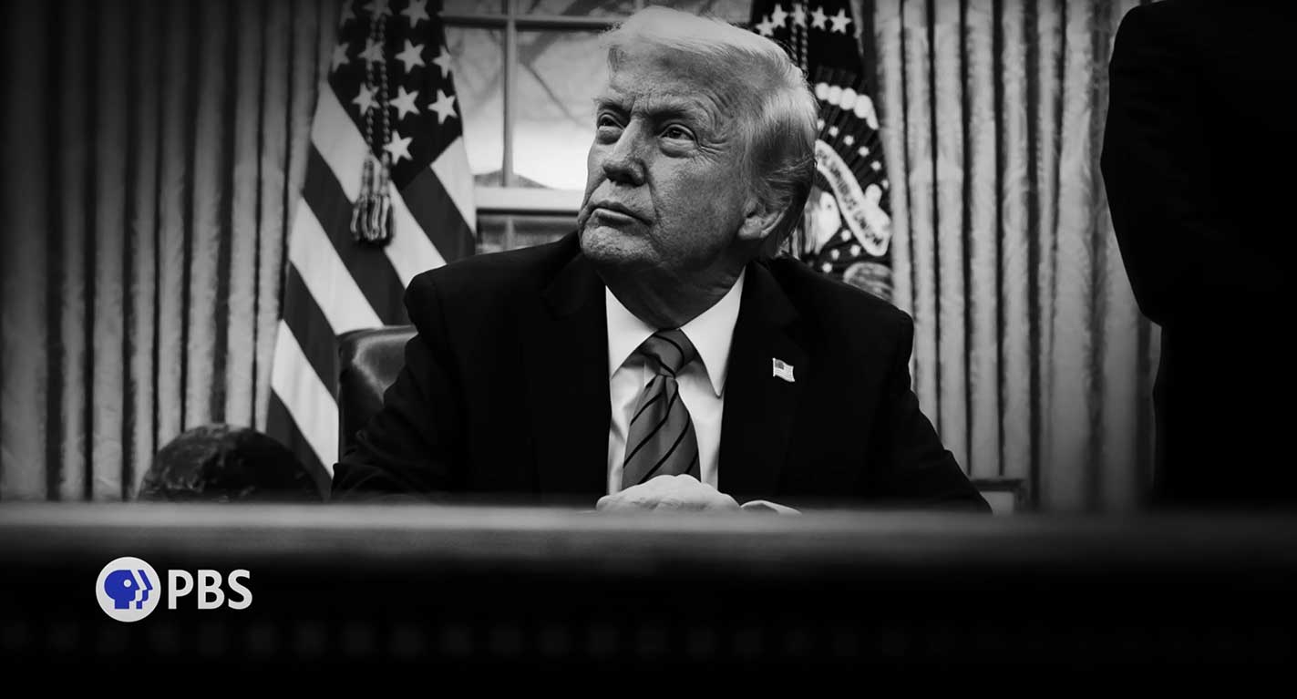 A black-and-white photo depicts Donald Trump seated at a desk, looking to the middle distance. He is an older man with light wavy hair and he is wearing a suit. American Flags are behind him. In the lower left quadrant of the frame is the blue and white PBS logo.