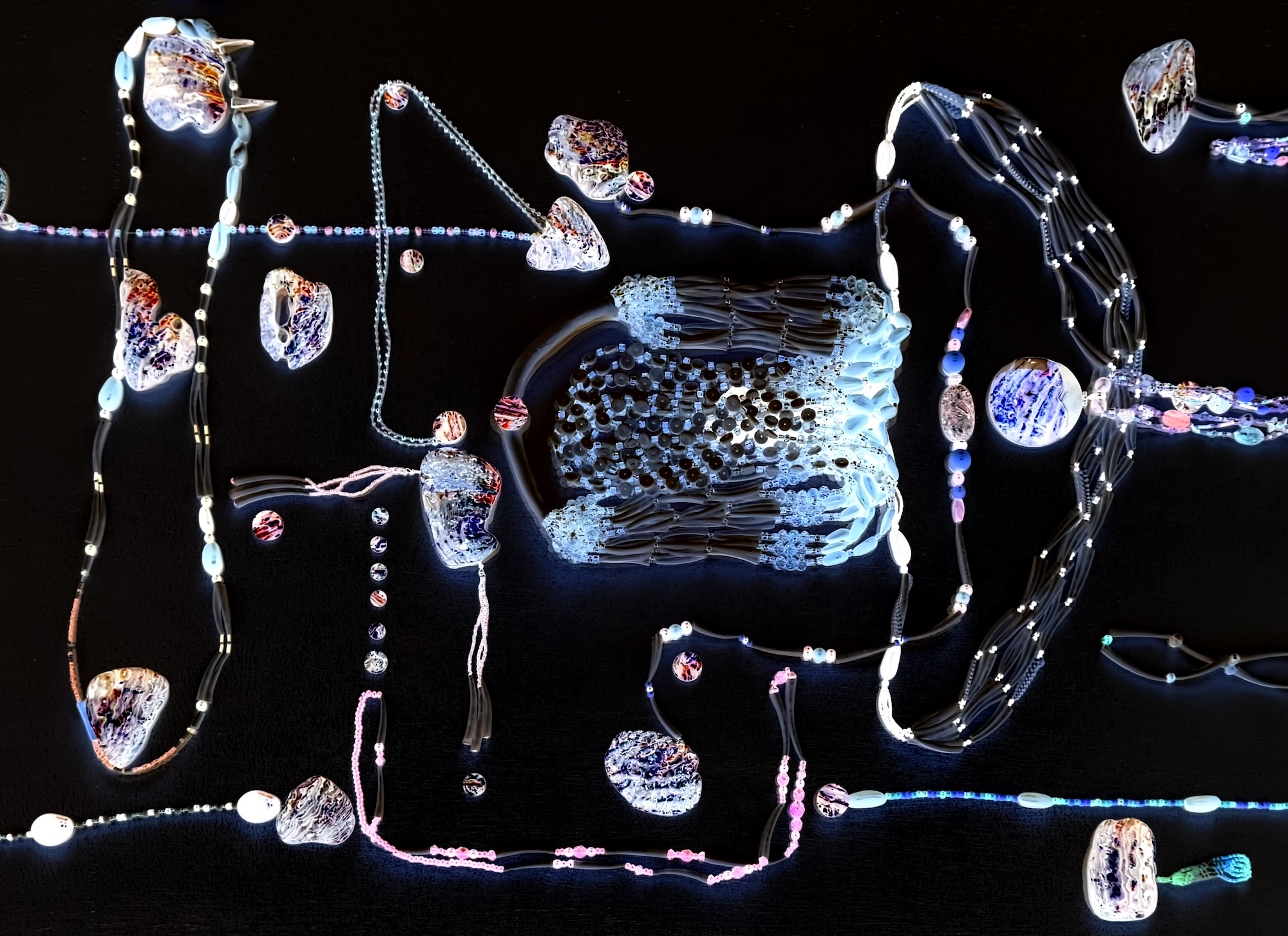 A piece of digital abstract artwork depicts beaded, interconnected shapes in various shades of light blue, pink and turquoise against a black background.