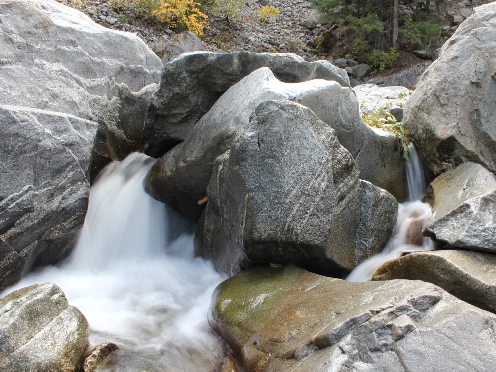 Water rushes over rocks in a mountain creek.