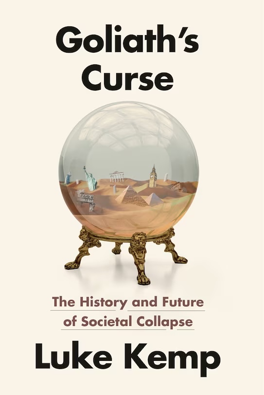 The book cover image for &lsquo;Goliath&rsquo;s Curse: The History and Future of Societal Collapse&rsquo; features a glass globe containing sand and recognizable miniatures of world monuments like the Statue of Liberty and the pyramids against a beige background.