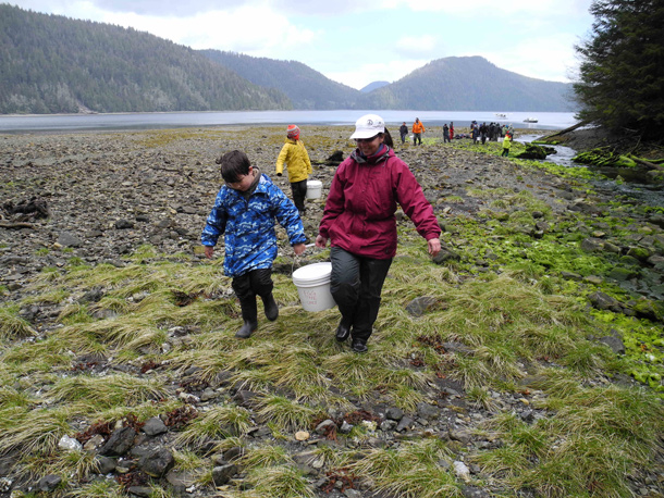 Kids carrying salmon fry