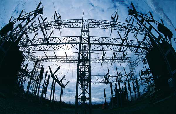 An electricity substation is seen from below.