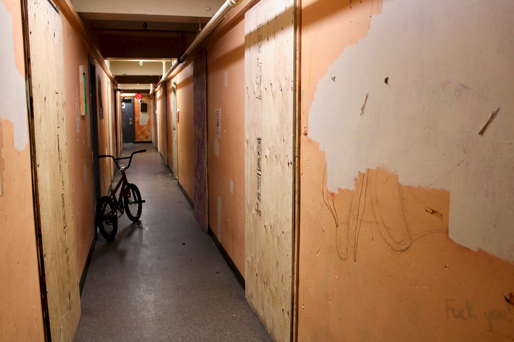 851px version of ColonialHotelBoardedHallwayDoors.jpg