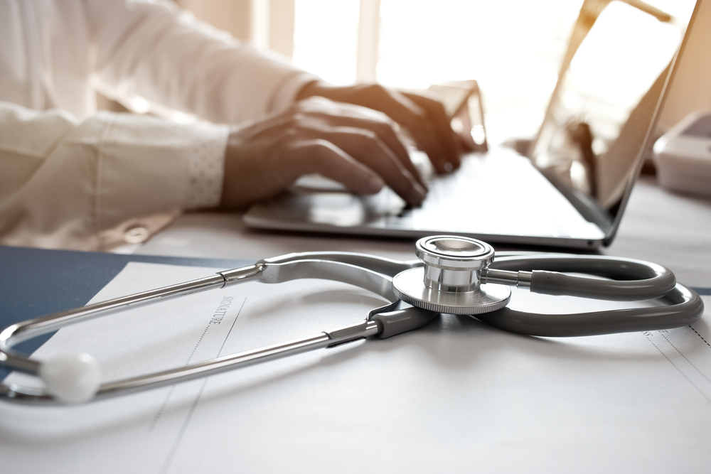 DoctorHandsLaptopDeskStethoscope.jpeg