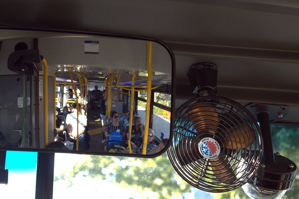The view from the rear window of the 255 bus that runs across the North Shore. One can see yellow fixtures, blue seats and a relatively light load of passengers because it&rsquo;s not rush hour. Even now, the bus is 20 minutes behind because the route is so challenging.