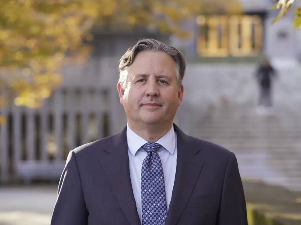 A profile photo of Mayor Kennedy Stewart. He wears a black suit and patterned tie. 