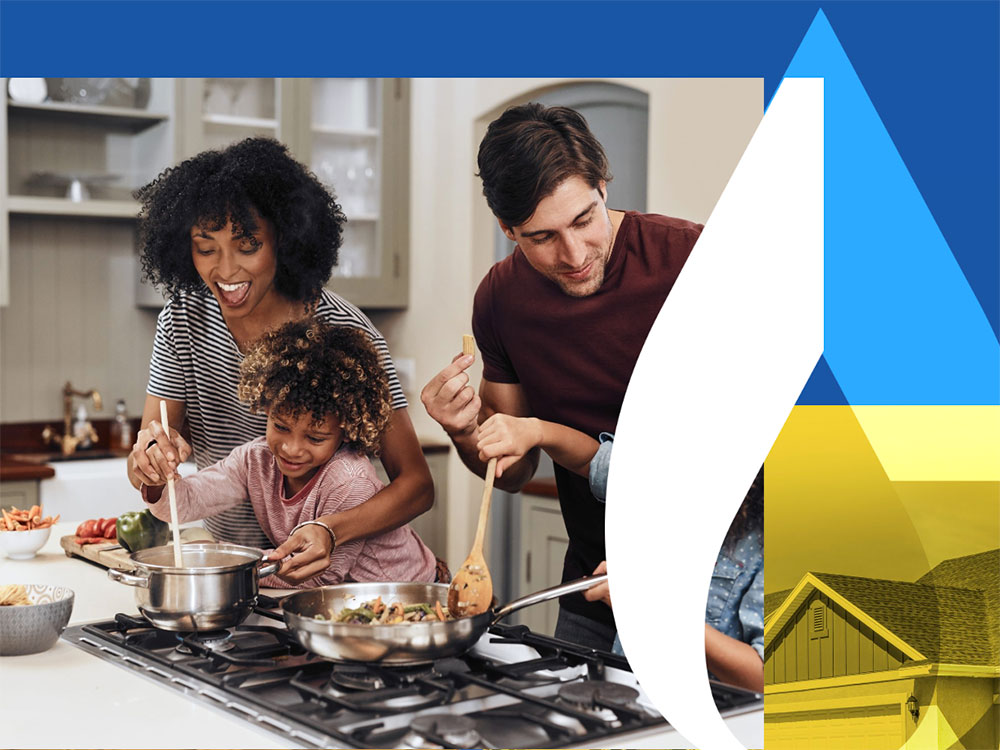 A family cooks together happily, using a gas stove.