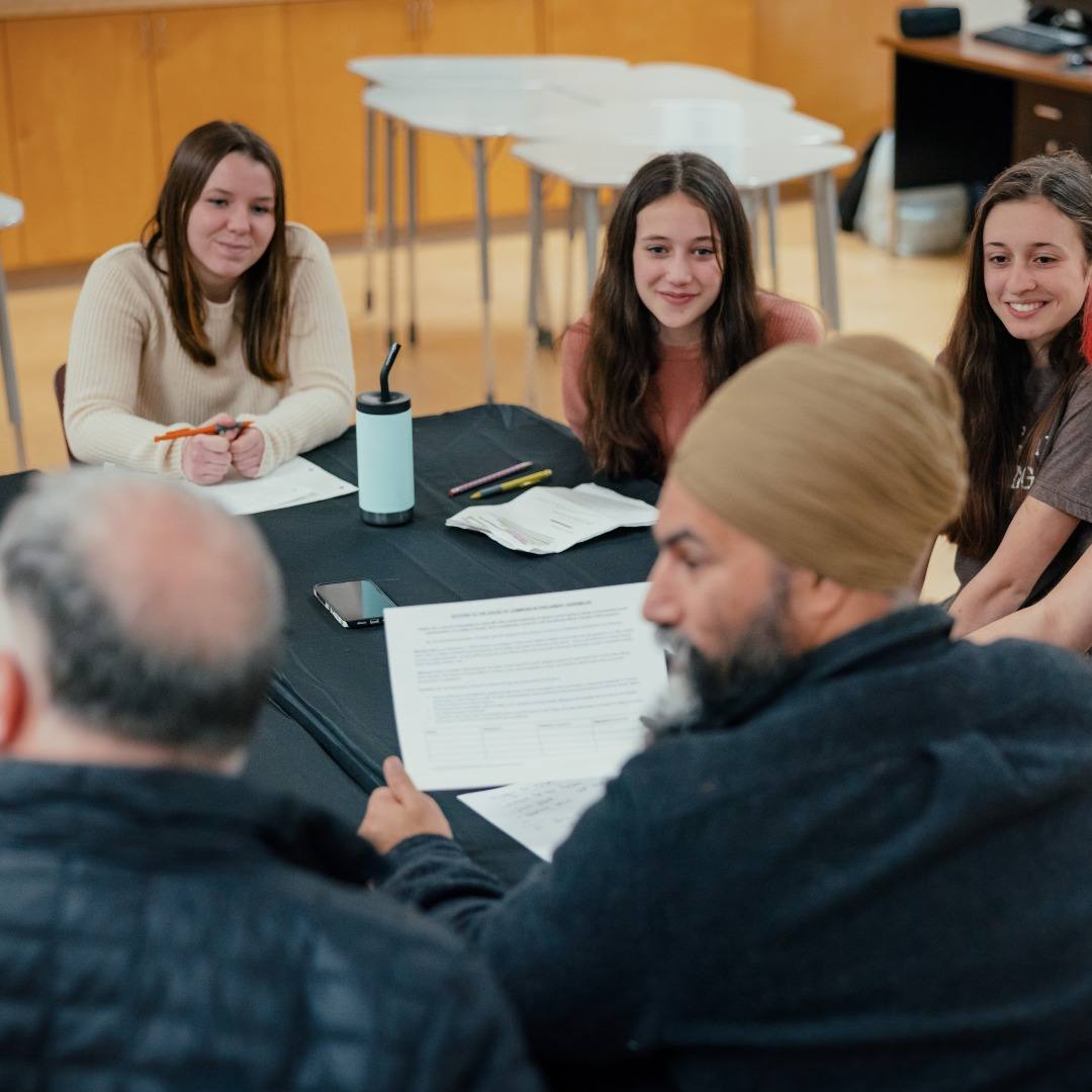NDP Party Leader Jagmeet Singh and NDP MP for Courtenay&ndash;Alberni, Gord Johns, sit around a table with four youth from the Qualicum Beach chapter of Fridays for the Future.
