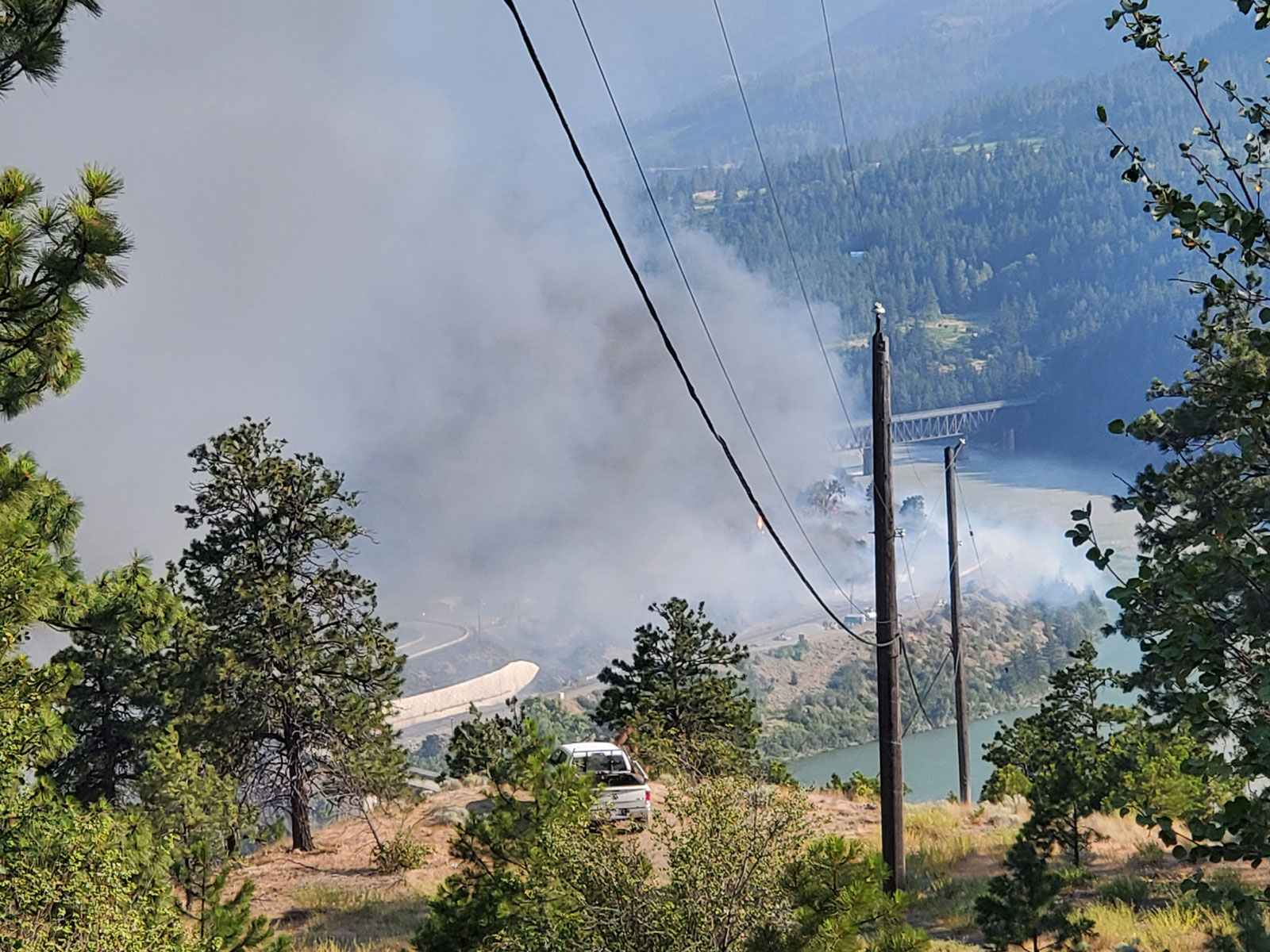 Looking down at a town in a valley covered in smoke.