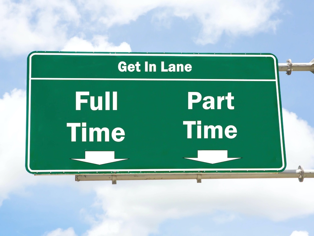 A green road sign with arrows pointing to the lanes below reads &ldquo;Full Time&rdquo; and &ldquo;Part Time,&rdquo; surrounded by a lightly clouded blue sky.
