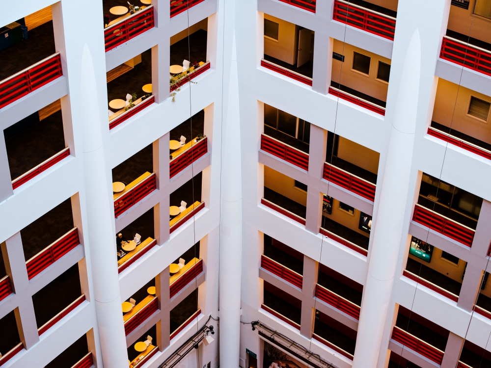 Looking down from above, several floors of the interior of the CBC Toronto building gleam red and white on March 7, 2023.