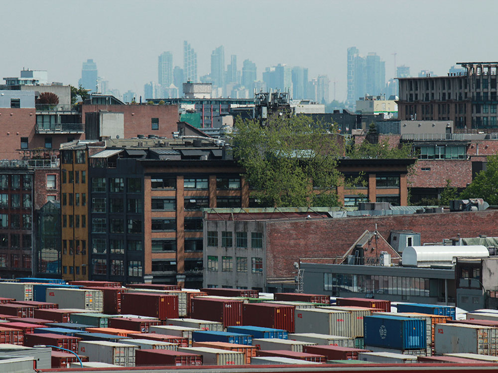 Looking over Gastown, buildings in the foreground and middle ground are clearly visible; buildings in the background are blanketed in haze.