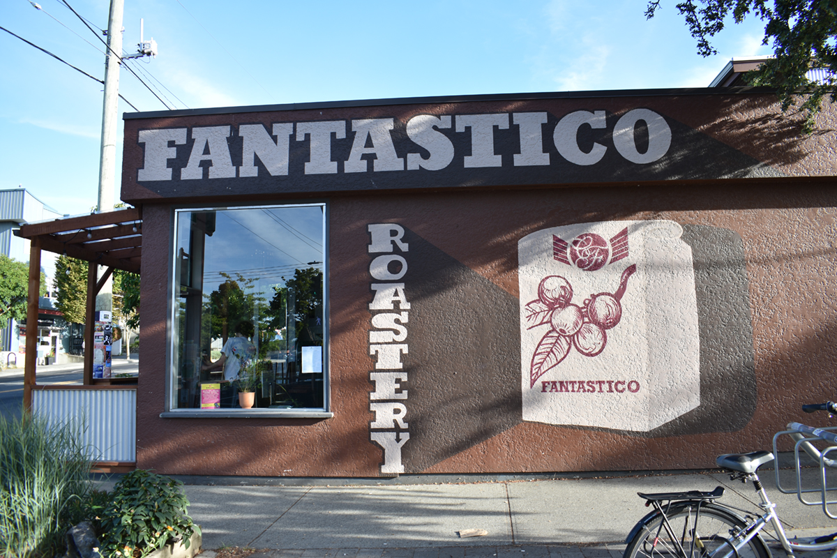 The outside of Caffe Fantastico. The walls are painted in rich browns, reminiscent of coffee. &lsquo;FANTASTICO ROASTERY&rsquo; is painted on the wall.