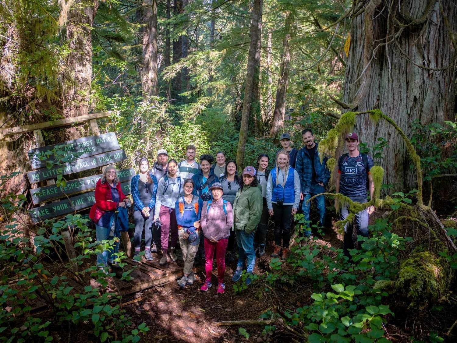 Students pose for a photo in the forest.