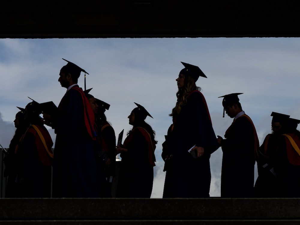 A low-contrast photo of graduating university students.