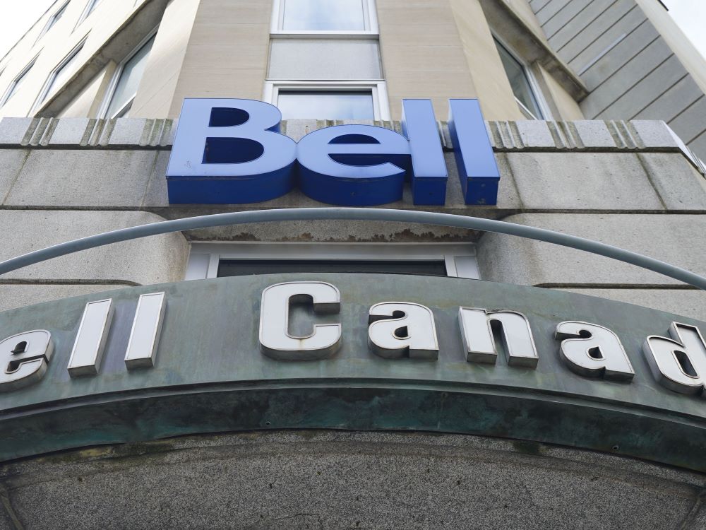 A grey office building rises into the sky. On the facade are logos that say &lsquo;Bell&rsquo; in blue letters and &lsquo;Bell Canada&rsquo; in grey.