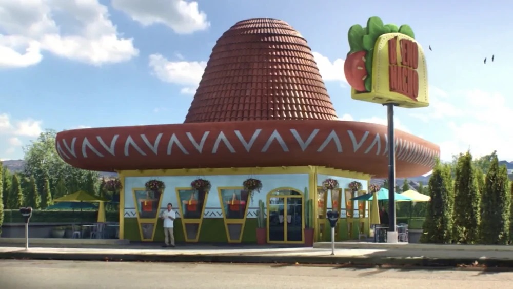 The pizza hut building has been turned into a restaurant topped with a sombrero-shaped roof.