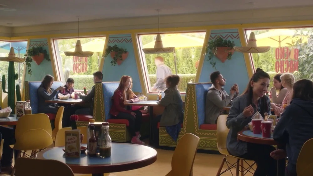 The interior of the Pizza Hut, which has been turned into a vibrant, colourful Mexican restaurant with sombrero lights.
