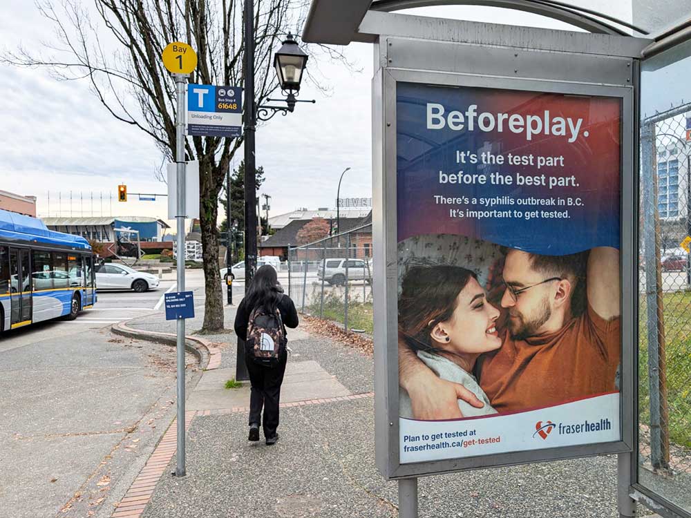 A bus stop ad advertises free and confidential testing and treatment for syphilis.