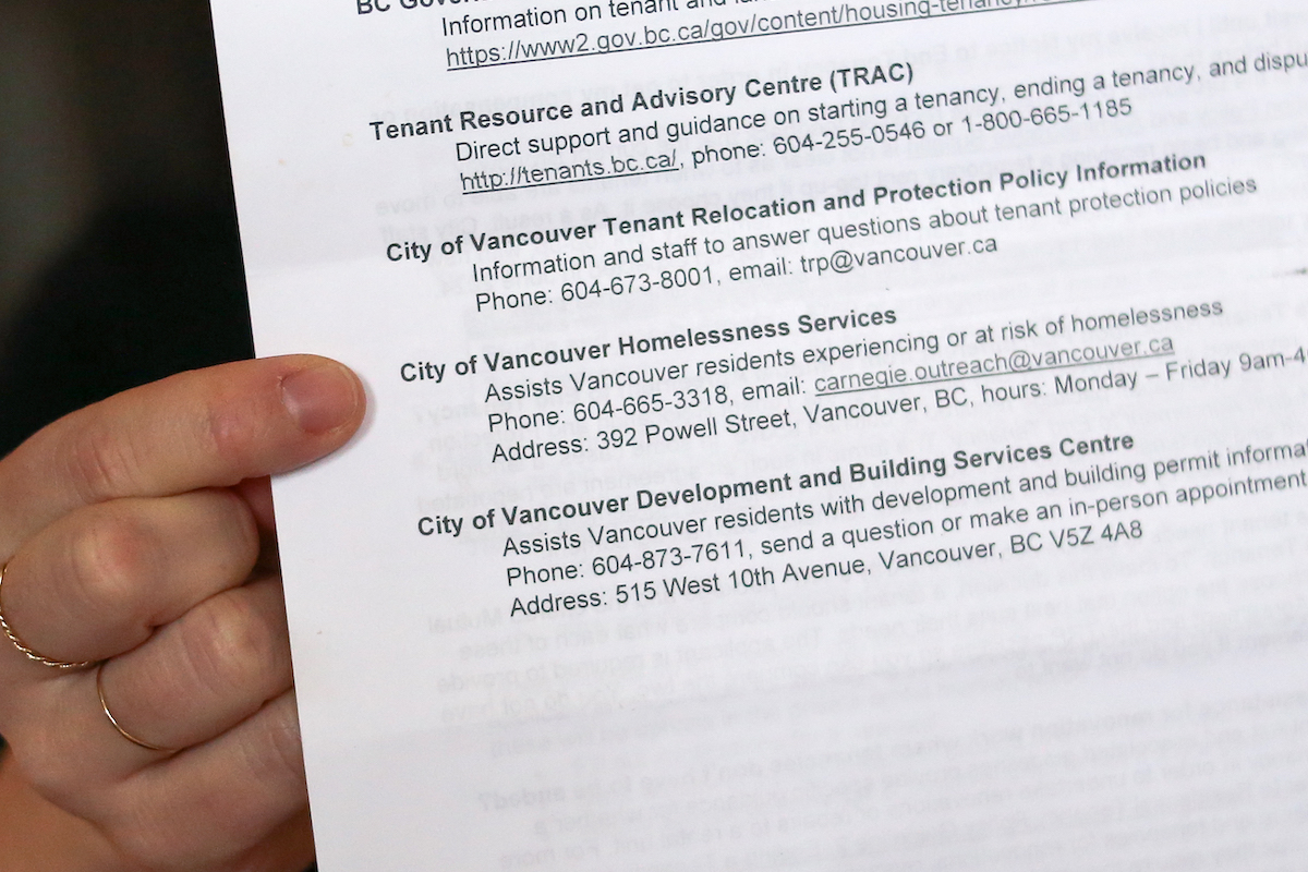 A close-up of a black and white printout listing tenant resource and homelessness services.