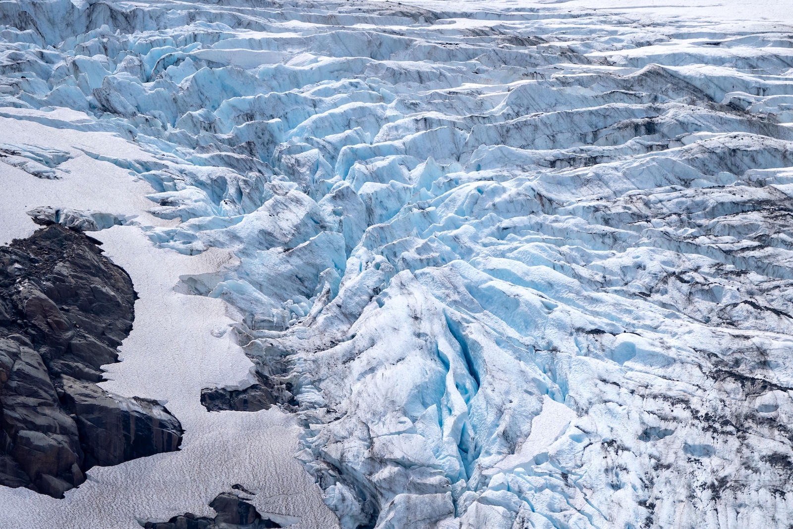 A glacier up close &mdash; blue white and deeply grooved.