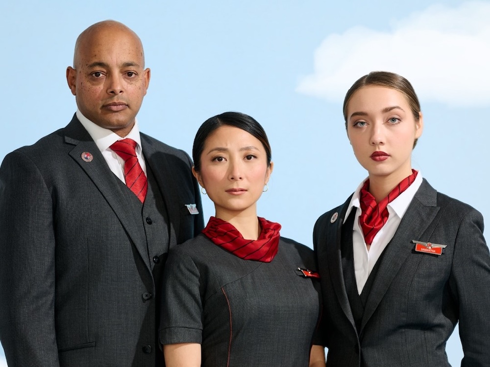 Three flight attendants, one man and two women.