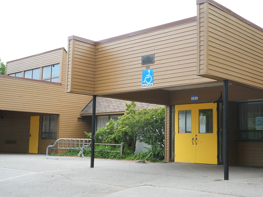 An entrance to Van Tech high school. A blue sign reading &lsquo;wheelchair access&rsquo; has an arrow directing people to the left. 