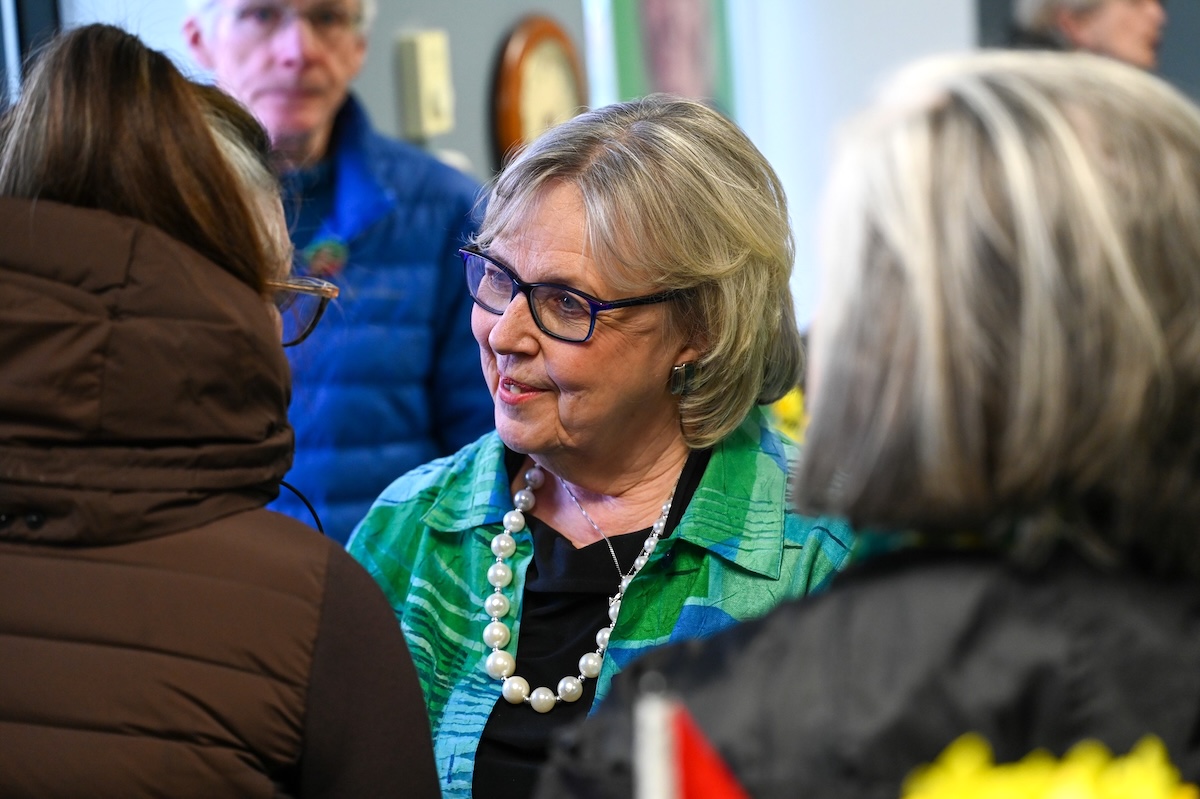 Elizabeth May speaks with supporters.